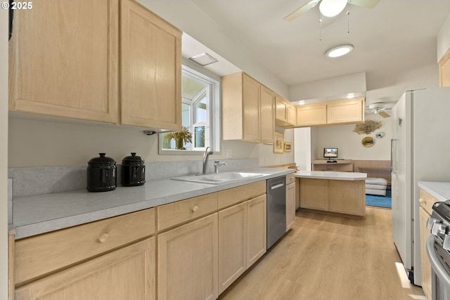 kitchen featuring a ceiling fan, a sink, appliances with stainless steel finishes, and light brown cabinets
