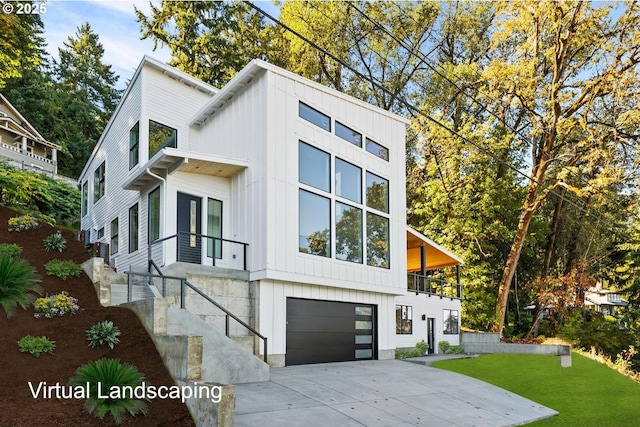 view of home's exterior featuring a yard, board and batten siding, concrete driveway, and a garage