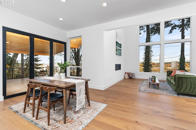 dining space with recessed lighting, baseboards, and light wood-type flooring
