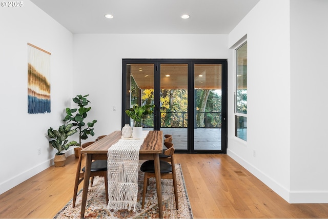 dining room featuring recessed lighting, baseboards, and light wood-style flooring