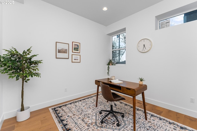 office area featuring baseboards, light wood-type flooring, and recessed lighting