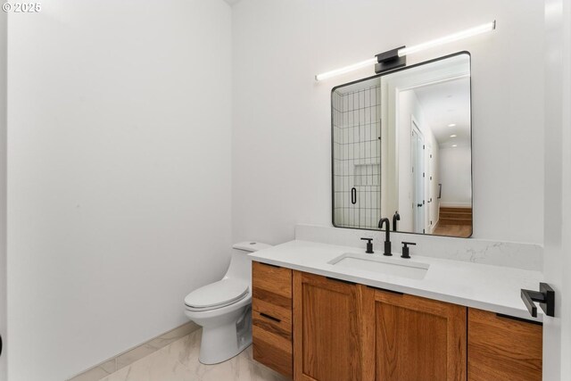 bathroom featuring vanity, marble finish floor, and toilet