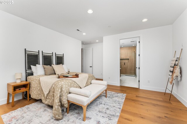 bedroom with recessed lighting, light wood-style floors, and baseboards