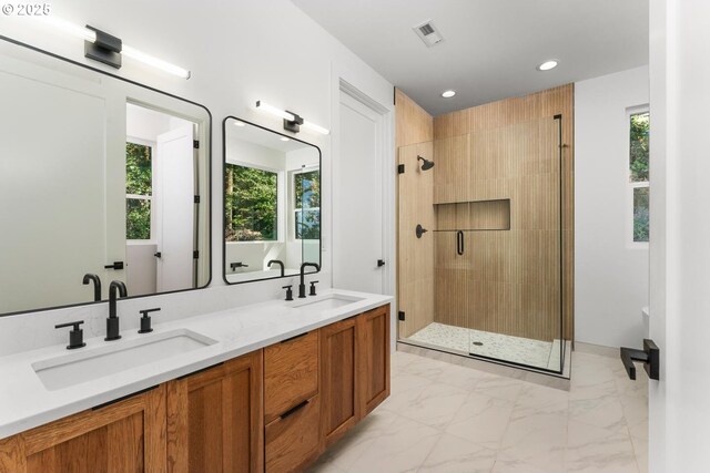 bathroom with a sink, a stall shower, recessed lighting, and marble finish floor
