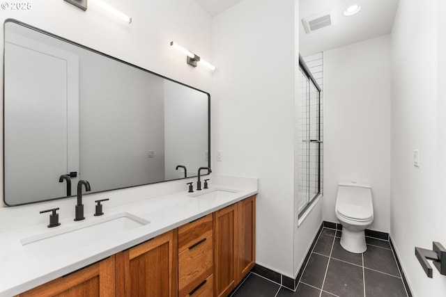 bathroom with a sink, tile patterned floors, toilet, and visible vents