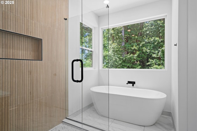 9316 NW Hardy Ave, Portland, OR 97231 - bathroom featuring marble finish floors, a freestanding bath, healthy amount of natural light, and baseboards