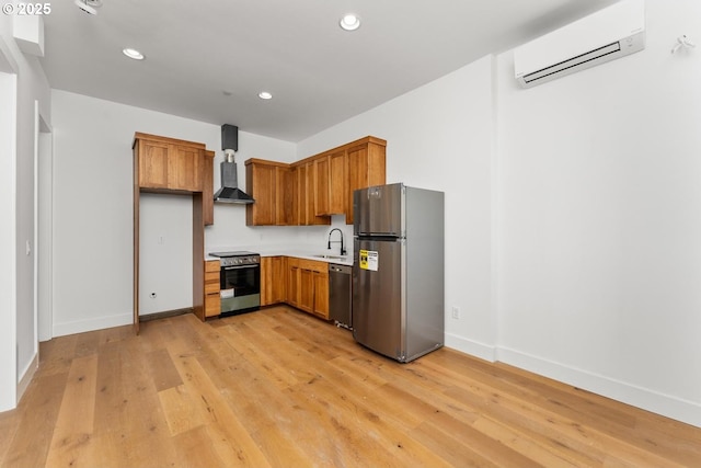 9316 NW Hardy Ave, Portland, OR 97231 - kitchen with stainless steel appliances, wall chimney range hood, a wall mounted air conditioner, a sink, and light wood-style floors