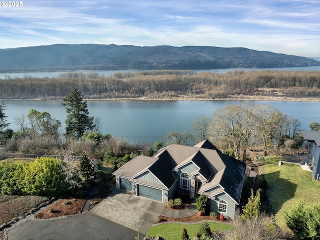 birds eye view of property with a water and mountain view