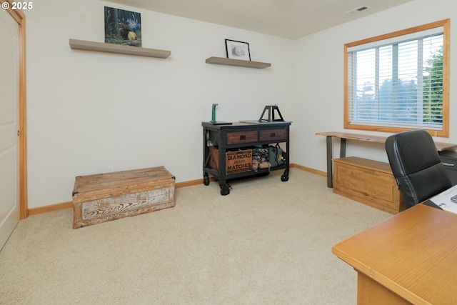 carpeted office with visible vents and baseboards