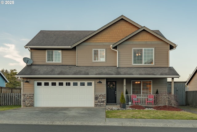 craftsman house featuring fence, driveway, an attached garage, covered porch, and a shingled roof