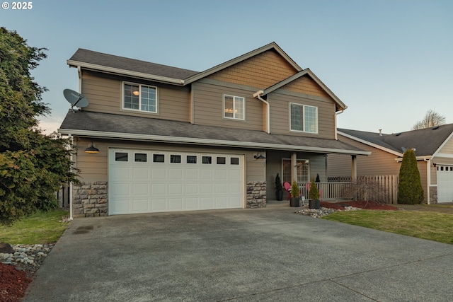 craftsman-style house featuring stone siding, covered porch, concrete driveway, and a garage