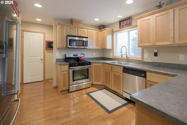 kitchen with light brown cabinetry, recessed lighting, appliances with stainless steel finishes, and a sink