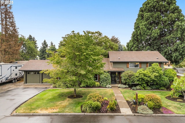 20060 SW Clarion St, Beaverton, OR 97003 - tri-level home featuring asphalt driveway, an attached garage, and a front yard