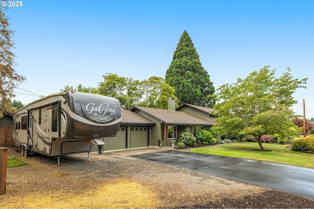 20060 SW Clarion St, Beaverton, OR 97003 - view of front facade with a garage, driveway, a front yard, and a chimney