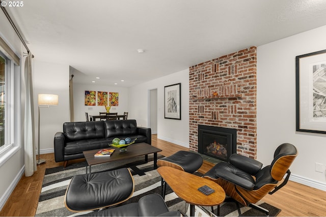 20060 SW Clarion St, Beaverton, OR 97003 - living room with wood finished floors, a brick fireplace, and recessed lighting