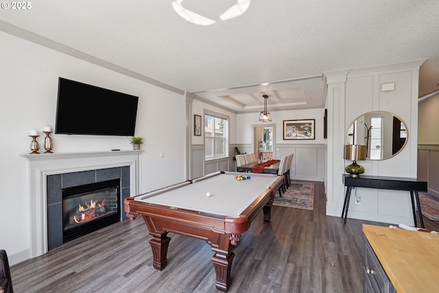 3753 NW Talamore Ter, Portland, OR 97229 - recreation room featuring dark wood-style floors, a raised ceiling, pool table, a fireplace, and a decorative wall
