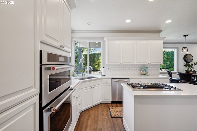3753 NW Talamore Ter, Portland, OR 97229 - kitchen with appliances with stainless steel finishes, healthy amount of natural light, wood finished floors, recessed lighting, and white cabinets