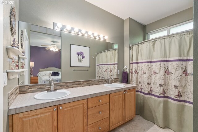 ensuite bathroom with a sink, ensuite bathroom, a ceiling fan, and double vanity