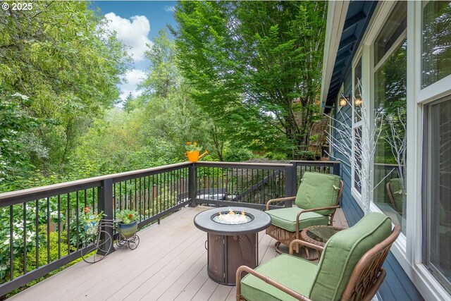 wooden deck featuring a fire pit