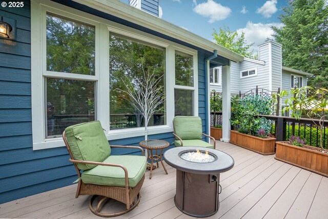 wooden deck featuring a fire pit