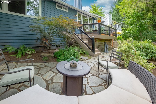 view of patio featuring stairs and a wooden deck