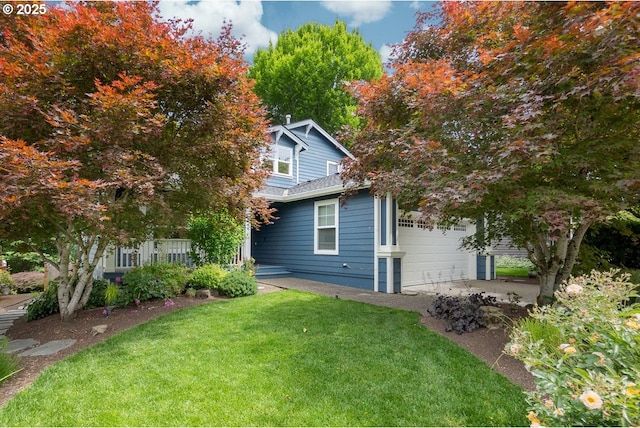 exterior space featuring a garage and a yard