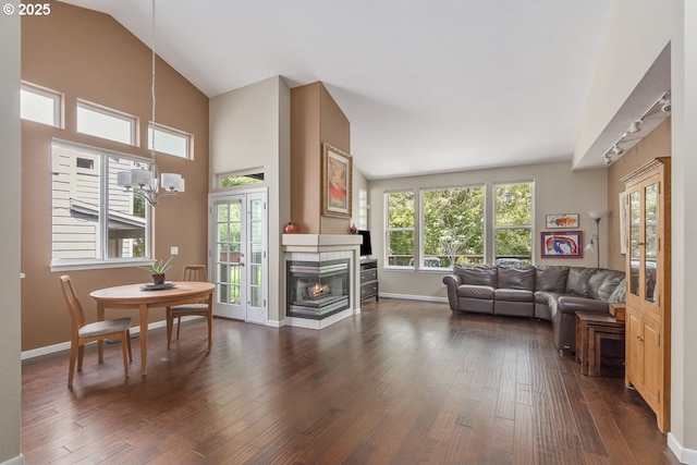 living room featuring dark wood finished floors, french doors, a fireplace, and baseboards