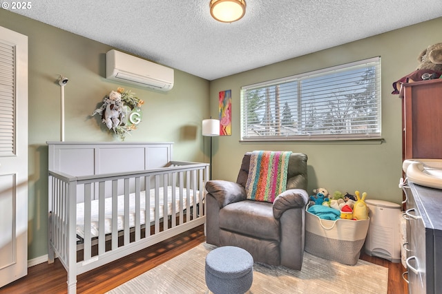 1592 NW Keasey St, Roseburg, OR 97471 - bedroom featuring a textured ceiling, wood finished floors, and an AC wall unit