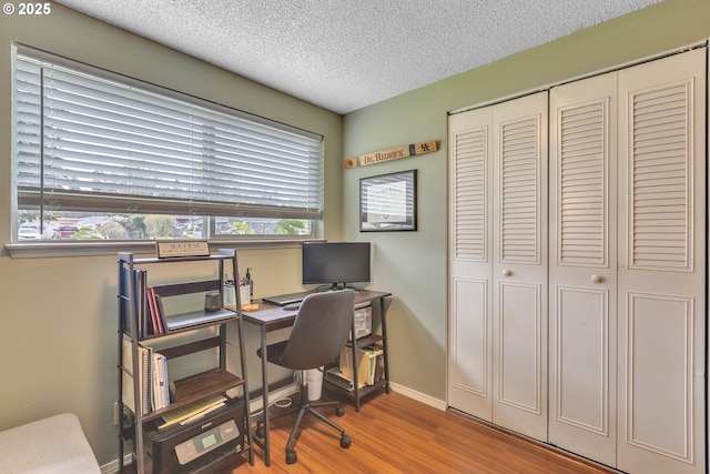 1592 NW Keasey St, Roseburg, OR 97471 - office area with a textured ceiling, wood finished floors, baseboards, and a healthy amount of sunlight