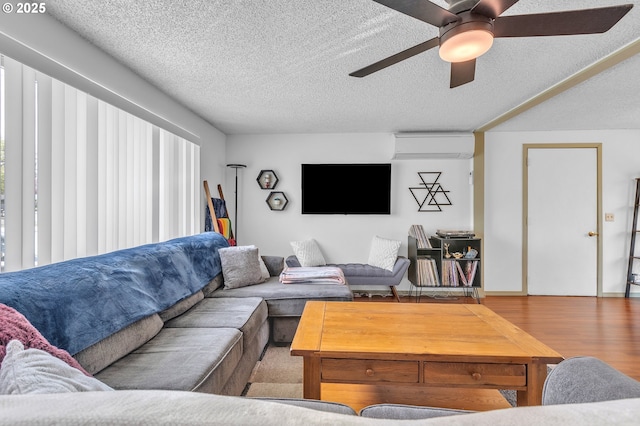 1592 NW Keasey St, Roseburg, OR 97471 - living room featuring a textured ceiling, a ceiling fan, wood finished floors, and a wall mounted air conditioner