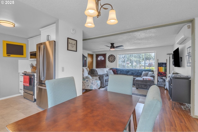 1592 NW Keasey St, Roseburg, OR 97471 - dining area featuring light wood-style floors, a textured ceiling, a ceiling fan, a wall mounted AC, and baseboards