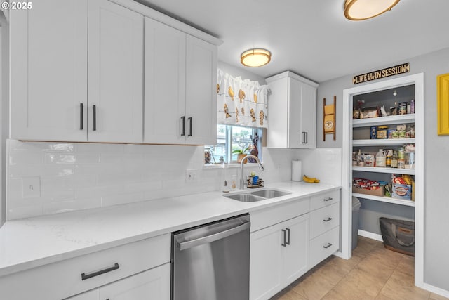 1592 NW Keasey St, Roseburg, OR 97471 - kitchen with stainless steel dishwasher, white cabinetry, light countertops, a sink, and backsplash
