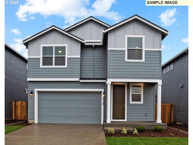 view of front of property featuring concrete driveway, board and batten siding, fence, and an attached garage