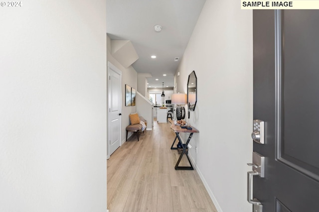 hallway with light hardwood / wood-style flooring