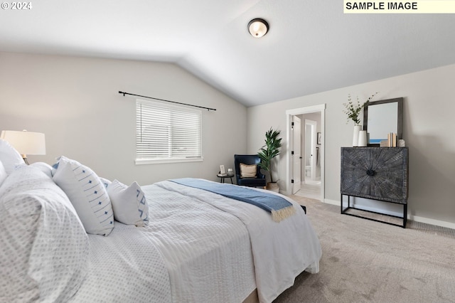 bedroom with lofted ceiling and light colored carpet