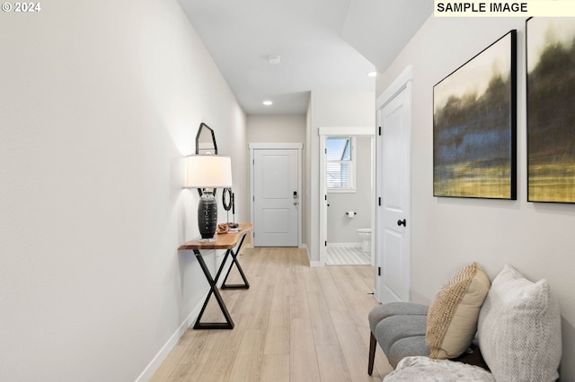 hallway with light hardwood / wood-style floors