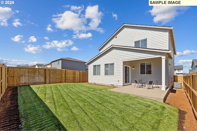 back of house featuring a patio and a yard