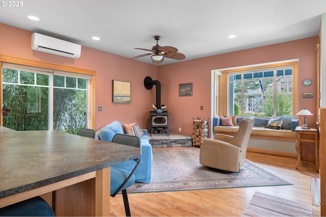 9180 Windward Ln, Manzanita, OR 97130 - living area featuring a wall mounted air conditioner, plenty of natural light, wood finished floors, and recessed lighting