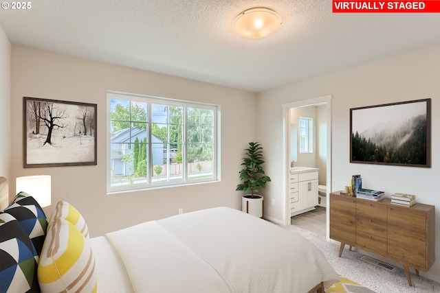 11329 NW Main St, North Plains, OR 97133 - bedroom with multiple windows, a textured ceiling, and ensuite bathroom