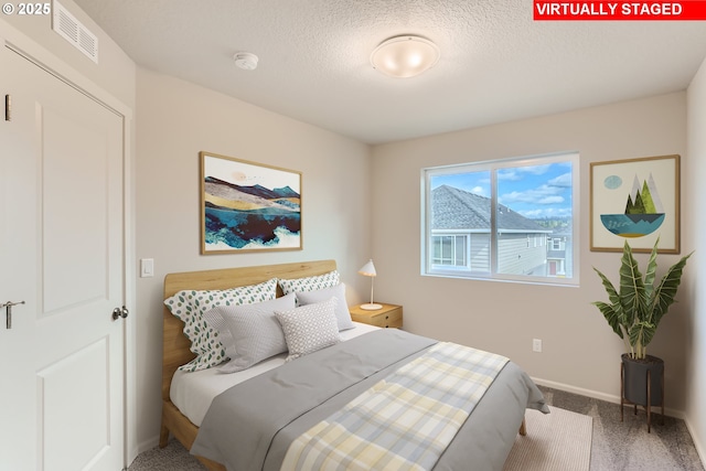 11329 NW Main St, North Plains, OR 97133 - bedroom featuring baseboards, carpet flooring, a textured ceiling, and visible vents