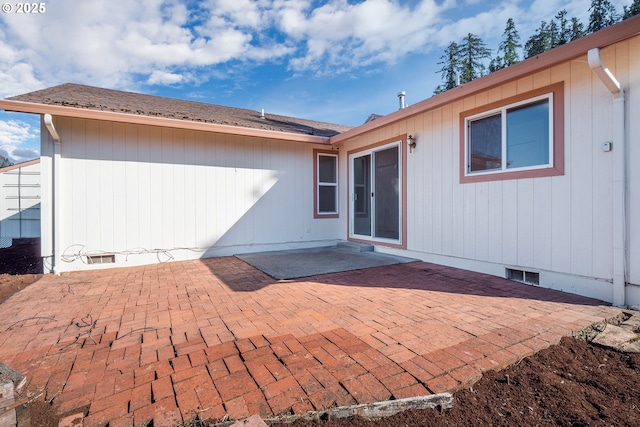 back of house with a patio area, visible vents, roof with shingles, and crawl space