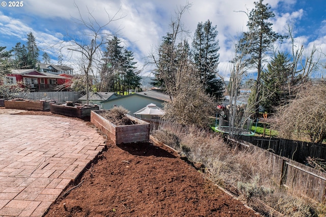 view of yard with a vegetable garden and fence