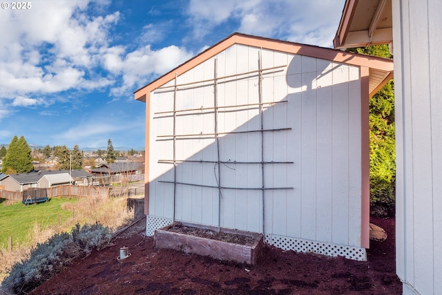 view of shed with fence