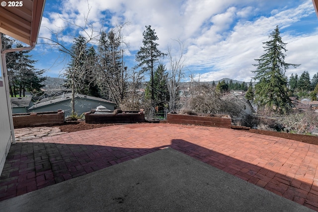 view of yard featuring a mountain view and a patio