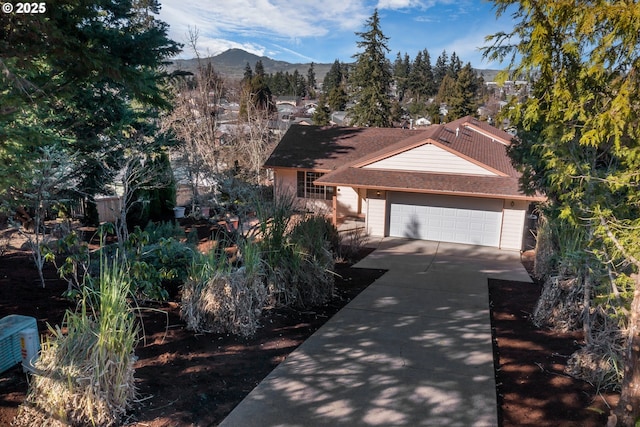 view of front of property with a mountain view, driveway, and an attached garage