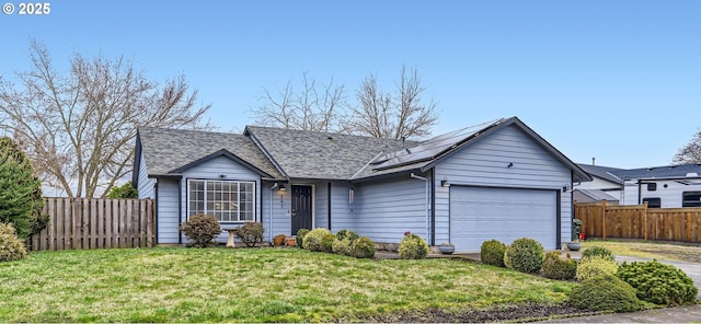 single story home with an attached garage, fence, a front lawn, and solar panels