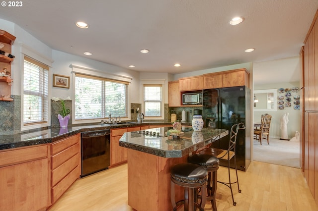 27975 S Cox Rd, Colton, OR 97017 - kitchen with black appliances, a sink, recessed lighting, healthy amount of natural light, and a kitchen bar