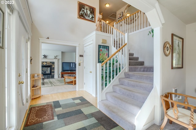 27975 S Cox Rd, Colton, OR 97017 - entryway featuring stairs, a towering ceiling, a fireplace, and wood finished floors
