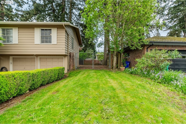 view of yard featuring a garage and fence