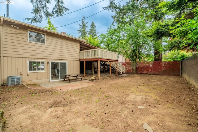 rear view of property with stairs, a wooden deck, a fenced backyard, central air condition unit, and a patio